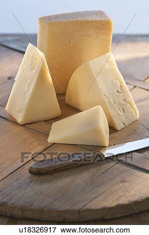 Stock Photo - Cheese on chopping board. Fotosearch