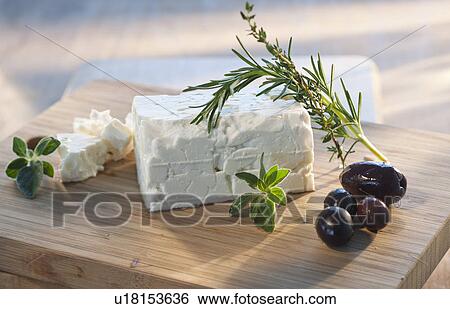 Cheese with herbs on chopping board View Large Photo Image Stock Photograph - Cheese with herbs on chopping board. Fotosearch