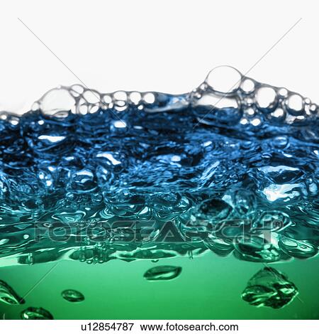 Stock Photo - Close up of blue and green water surface with bubbles. Fotosearch