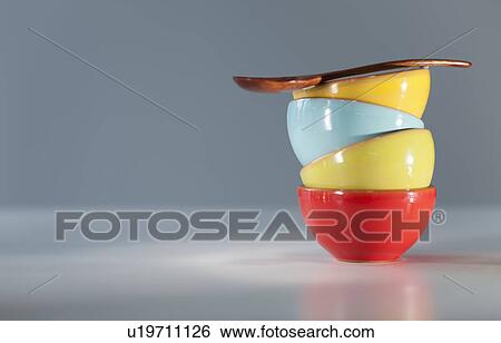 Stock Photograph - Colorful stacked bowls with spoon. Fotosearch