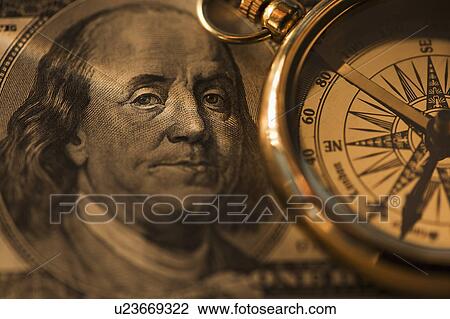 Stock Image - Compass on dollar bill. Fotosearch