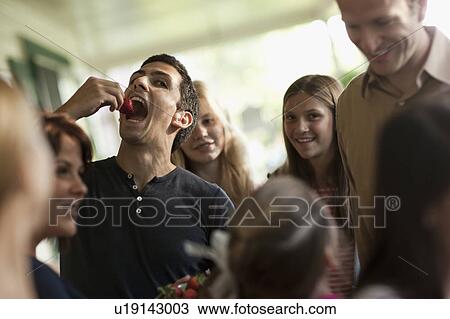 Stock Image - Family with girls (10-11, 14-15) during celebration event. Fotosearch