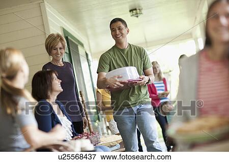 Stock Photo - Family with girls 10-11, 14-15) during celebration event. Fotosearch