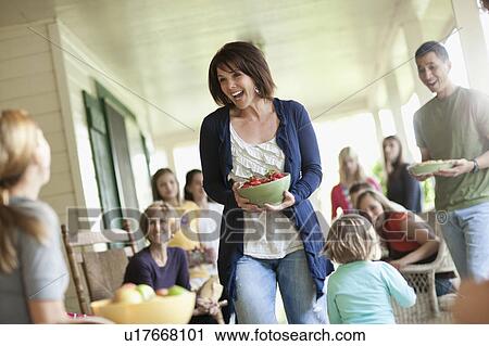 Stock Image - Family with girls (10-11, 2-3, 14-15) during celebration event. Fotosearch