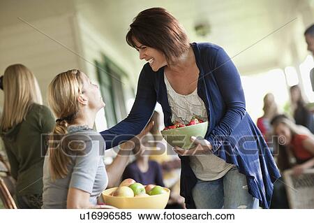 Stock Photography - Family with girls (10-11, 2-3, 14-15) during celebration event. Fotosearch