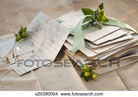 Picture - Flowers on pile of letters. Fotosearch
