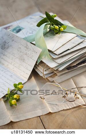 Stock Image - Flowers on pile of letters. Fotosearch