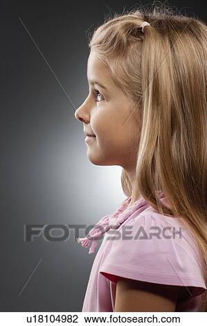 Girl (8-9) looking up, studio shot View Large Photo Image Stock Image - Girl (8-9) looking up, studio shot. Fotosearch