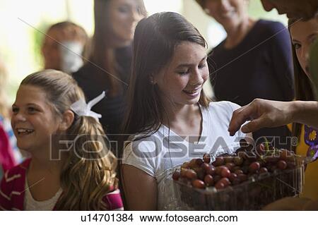 Picture - Girls (10-11, 14-15) and family during celebration event. Fotosearch