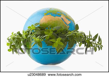 Stock Photo - Globe in wreath of fresh leaves. Fotosearch