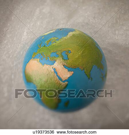Stock Photograph - Globe lying on bubble wrap. Fotosearch