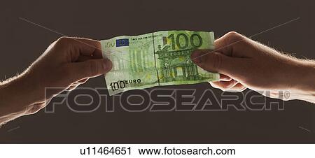 Hands holding one hundred euro note View Large Photo Image Stock Image - Hands holding one hundred euro note. Fotosearch