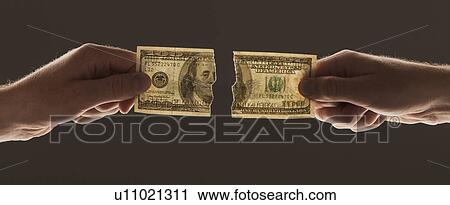 Hands holding torn one hundred dollar bill View Large Photo Image Stock Image - Hands holding torn one hundred dollar bill. Fotosearch