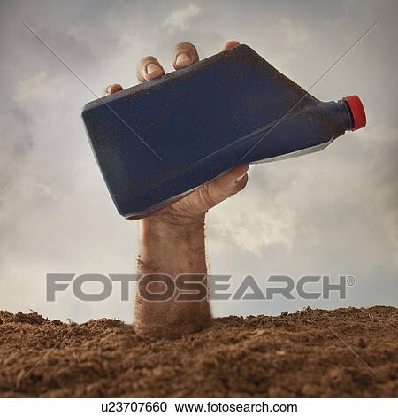Stock Image - Human hand holding plastic bottle, studio shot. Fotosearch