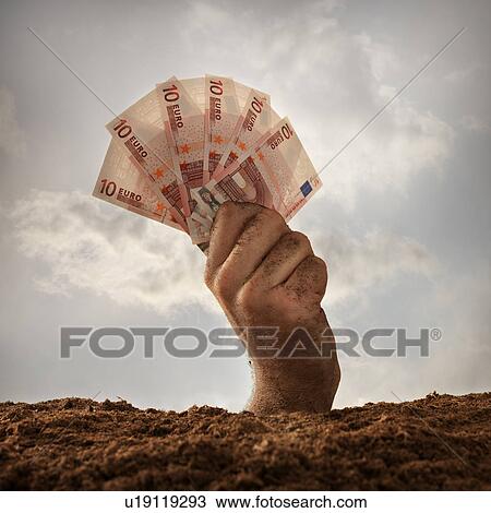 Stock Image - Human hand holding ten euros banknotes, studio shot. Fotosearch