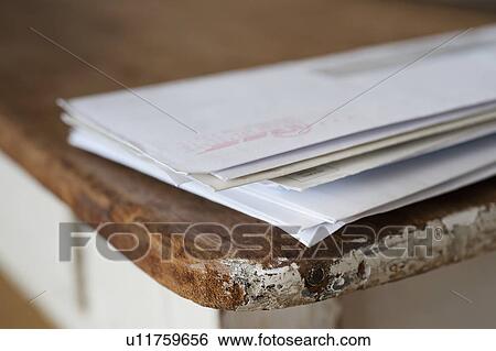 Stock Photograph - Letters on the egde of table. Fotosearch
