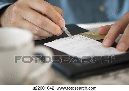 Stock Image - Man signing bill. Fotosearch