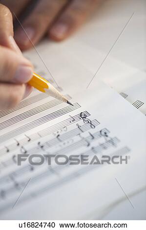 Man writing notes on sheet music View Large Photo Image Stock Image - Man writing notes on sheet music. Fotosearch