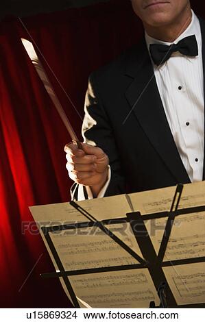 Picture - Midsection of orchestra conductor. Fotosearch
