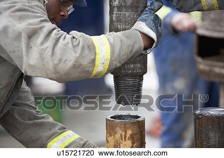Oil worker drilling for oil on rig View Large Photo Image Stock Image - Oil worker drilling for oil on rig. Fotosearch