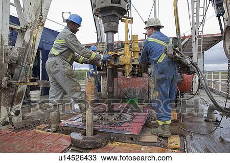 Oil workers drilling for oil on rig View Large Photo Image Stock Image - Oil workers drilling for oil on rig. Fotosearch