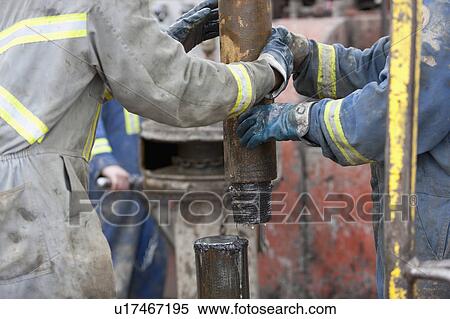 Stock Photography - Oil workers drilling for oil on rig. Fotosearch