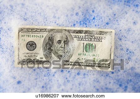 One hundred dollar bill soaking in soap sud View Large Photo Image Stock Photo - One hundred dollar bill soaking in soap sud. Fotosearch