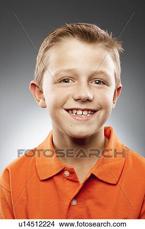 Portrait of boy (8-9) wearing polo shirt and looking at camera, studio shot View Large Photo Image Picture - Portrait of boy (8-9) wearing polo shirt and looking at camera, studio shot. Fotosearch