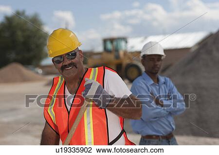 Stock Image - Portrait of construction workers on building site. Fotosearch