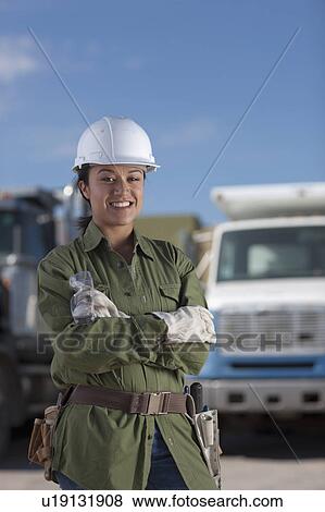 Stock Photo - Portrait of female construction worker on building site. Fotosearch
