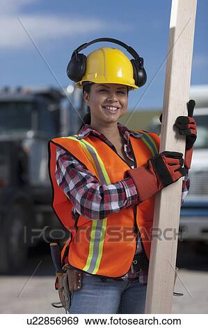 Portrait of female construction worker on building site View Large Photo Image Stock Photo - Portrait of female construction worker on building site. Fotosearch