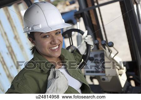 Portrait of female construction worker driving mechanical digger View Large Photo Image Stock Photo - Portrait of female construction worker driving mechanical digger. Fotosearch