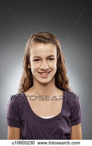 Portrait of girl (12-13) looking at camera and smiling, studio shot View Large Photo Image Stock Image - Portrait of girl (12-13) looking at camera and smiling, studio shot. Fotosearch