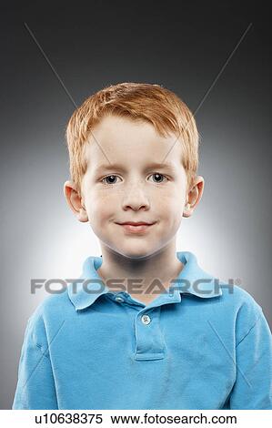 Portrait of smiling redhead boy (4-5) wearing blue polo shirt, studio shot View Large Photo Image Stock Photography - Portrait of smiling redhead boy (4-5) wearing blue polo shirt, studio shot. Fotosearch