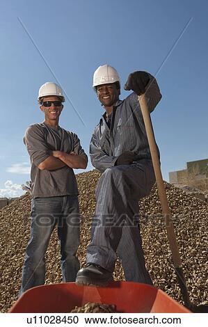 Portrait of two construction workers by rubble on building site View Large Photo Image Stock Image - Portrait of two construction workers by rubble on building site. Fotosearch
