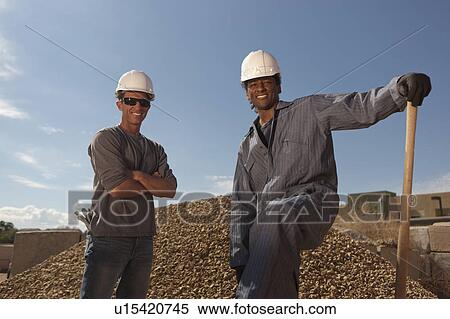 Portrait of two construction workers by rubble on building site View Large Photo Image Stock Photography - Portrait of two construction workers by rubble on building site. Fotosearch