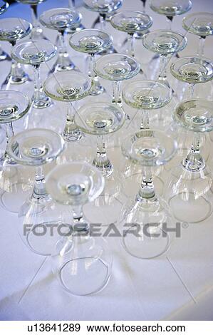 Rows of wine glasses on table View Large Photo Image Stock Photo - Rows of wine glasses on table . Fotosearch