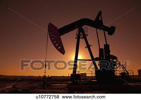 Stock Photo - Silhouette of oil pump jack on rig. Fotosearch