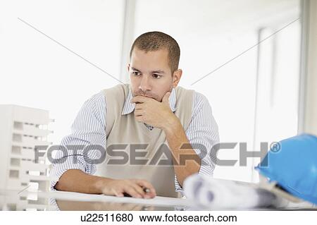Stock Image - South Africa, Architect working in office. Fotosearch