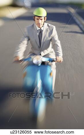 Stock Photography - South Africa, Businessman driving scooter, high angle view. Fotosearch
