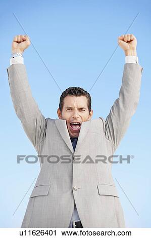 Stock Image - South Africa, Happy businessman, low angle view. Fotosearch