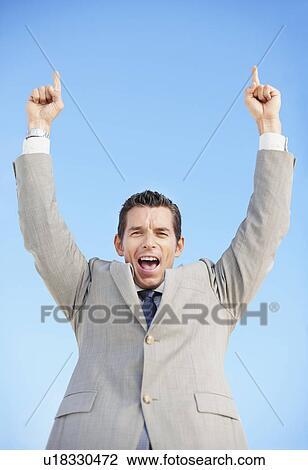 Stock Image - South Africa, Happy businessman, low angle view. Fotosearch