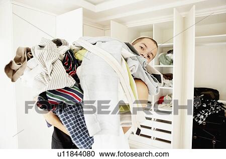 South Africa, Man standing with pile of laundry View Large Photo Image Stock Image - South Africa, Man standing with pile of laundry. Fotosearch