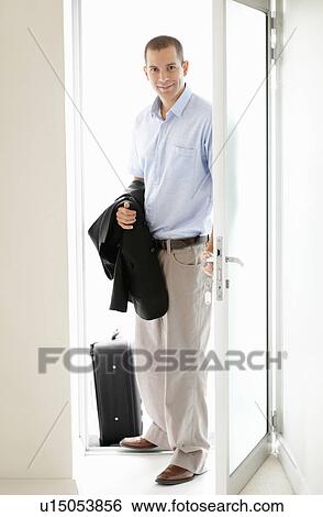 South Africa, Young businessman entering home View Large Photo Image Stock Photograph - South Africa, Young businessman entering home. Fotosearch