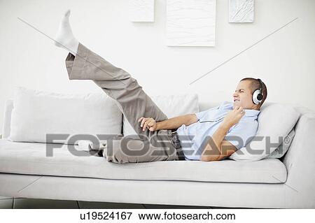 South Africa, Young man listening music and pretending to play guitar View Large Photo Image Stock Photo - South Africa, Young man listening music and pretending to play guitar. Fotosearch
