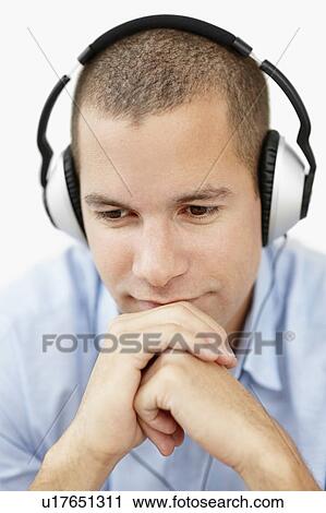 South Africa, Young man wearing earphones and looking away, studio shot View Large Photo Image Stock Image - South Africa, Young man wearing earphones and looking away, studio shot. Fotosearch