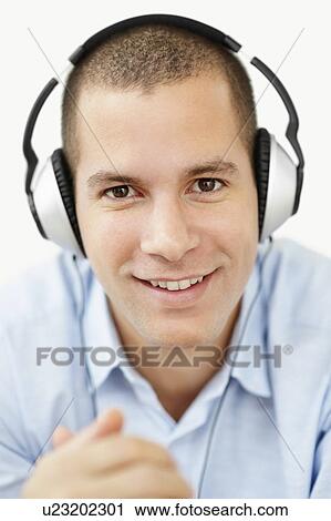 South Africa, Young man wearing earphones and looking at camera, studio shot View Large Photo Image Stock Image - South Africa, Young man wearing earphones and looking at camera, studio shot. Fotosearch