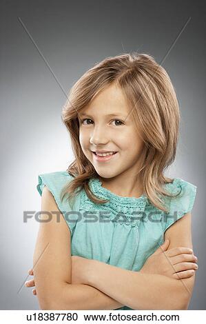 Studio portrait of girl (10-11) smiling View Large Photo Image Stock Image - Studio portrait of girl (10-11) smiling. Fotosearch