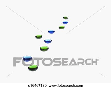 Stock Image - Studio shot of blue and green glass beads in row. Fotosearch
