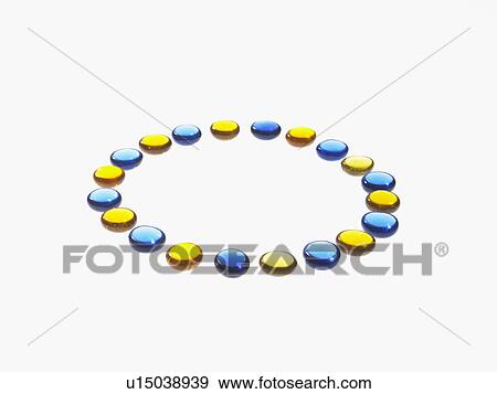 Stock Photo - Studio shot of blue and yellow glass beads in circle. Fotosearch